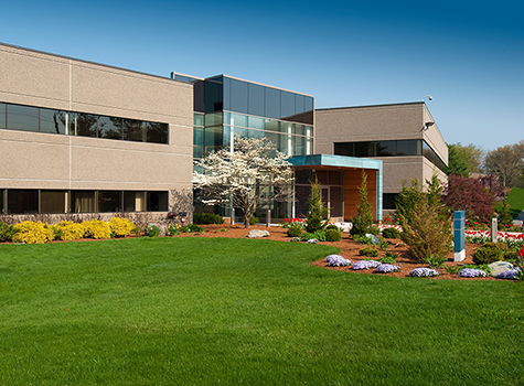 Commercial building with lawns and gardens at entrance