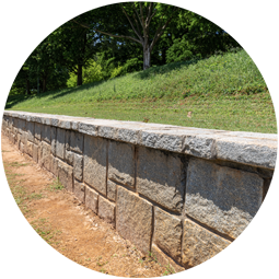 Stone retaining wall with grass on both sides